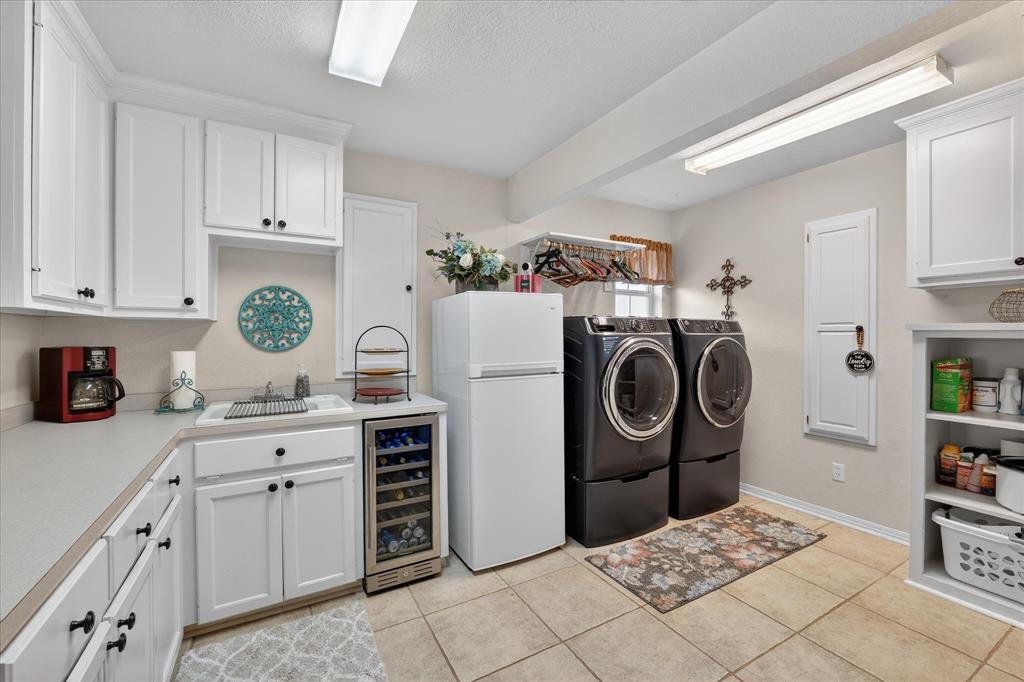 703 Gibraltar Lane Lorena, TX 76655 - Photo 16 of 39 a kitchen with kitchen island granite countertop a sink a stove a refrigerator and cabinets