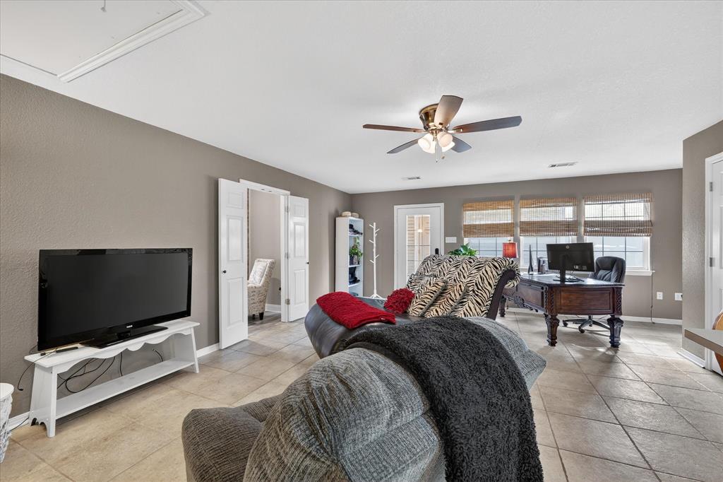 703 Gibraltar Lane Lorena, TX 76655 - Photo 17 of 39 a living room with furniture and a flat screen tv