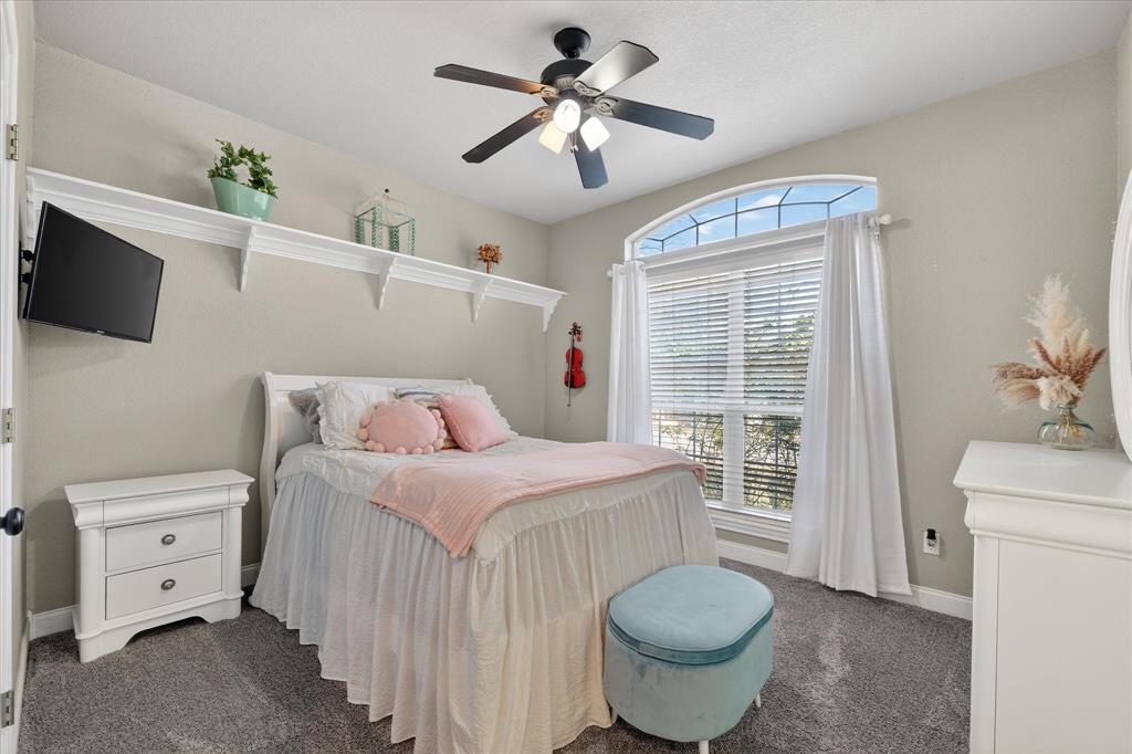 703 Gibraltar Lane Lorena, TX 76655 - Photo 22 of 39 a bedroom with a bed and a flat screen tv