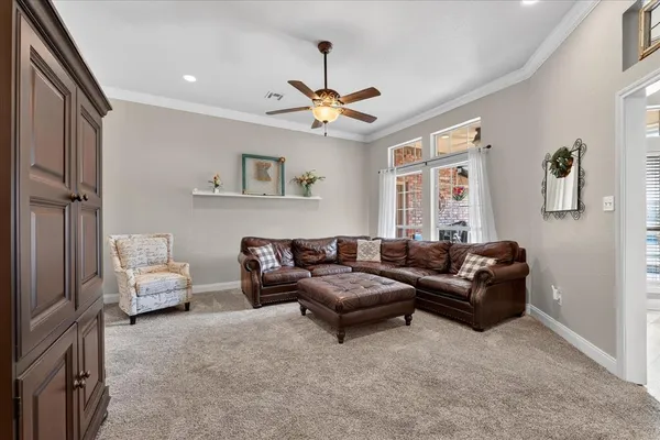 a living room with furniture and a chandelier