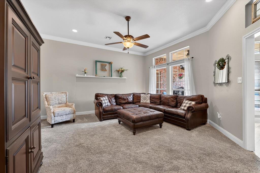 703 Gibraltar Lane Lorena, TX 76655 - Photo 24 of 39 a living room with furniture and a chandelier