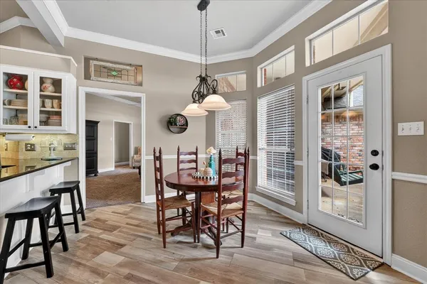 a dining room with furniture and window