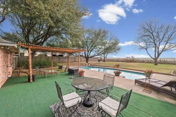 a view of a backyard with sitting area