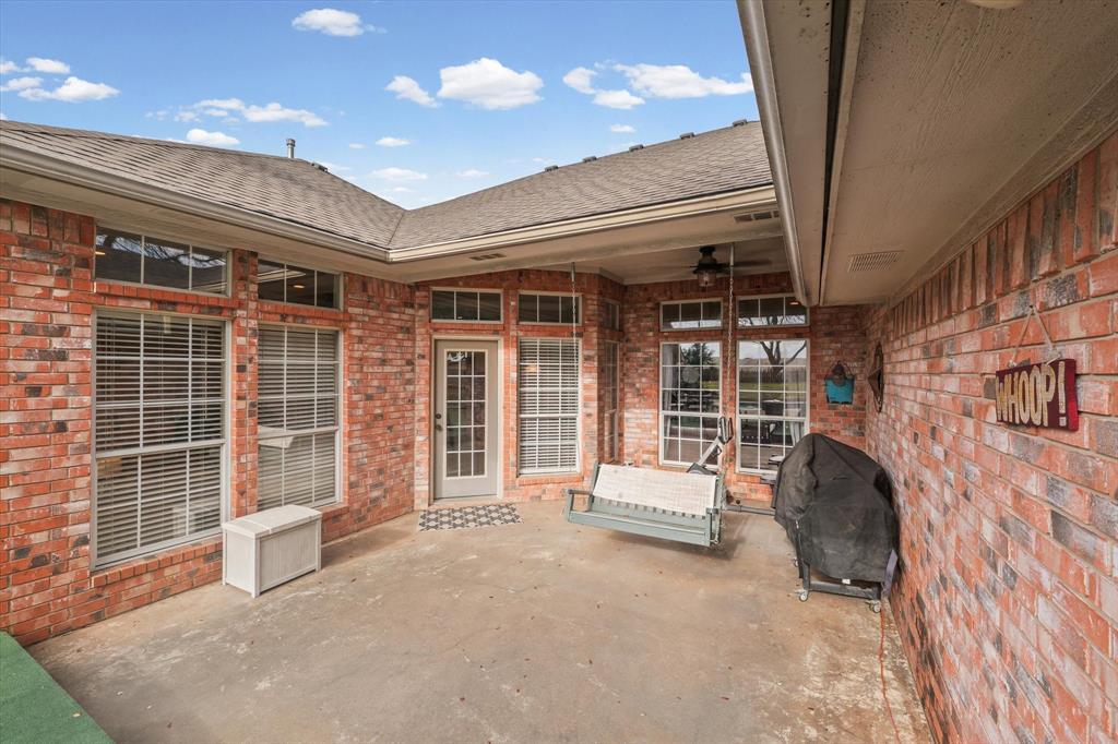 703 Gibraltar Lane Lorena, TX 76655 - Photo 36 of 39 a view of a patio with glass door and deck