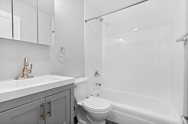 a bathroom with a sink a toilet and a bathtub