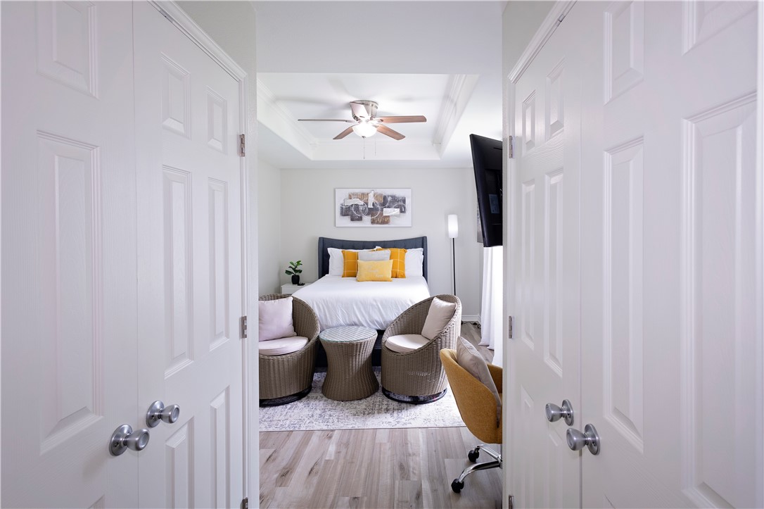 1217 O'Connell Street Corpus Christi, TX 78418 - Photo 17 of 23 a bedroom with a bed and a chandelier