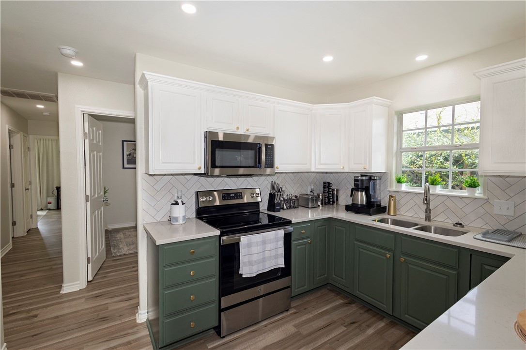 1217 O'Connell Street Corpus Christi, TX 78418 - Photo 5 of 23 a kitchen with a sink stove top oven and refrigerator