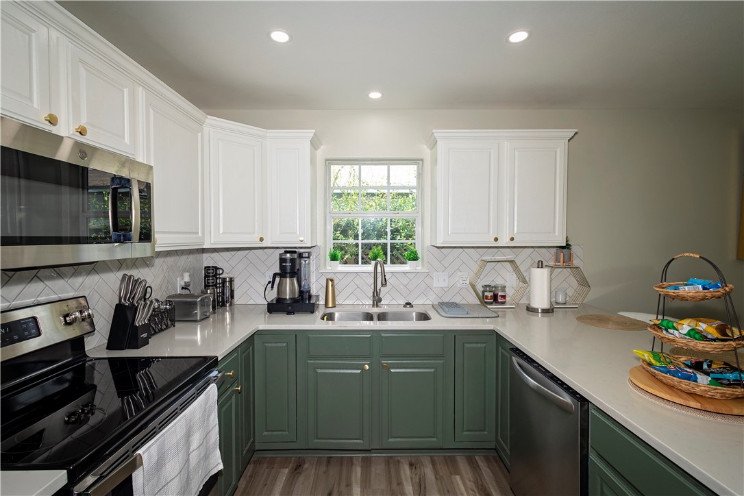 1217 O'Connell Street Corpus Christi, TX 78418 - Photo 6 of 23 a kitchen with a sink stove top oven and cabinets