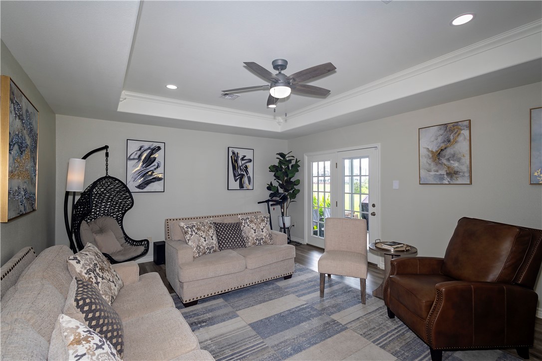 1217 O'Connell Street Corpus Christi, TX 78418 - Photo 7 of 23 a living room with furniture a chandelier and a window