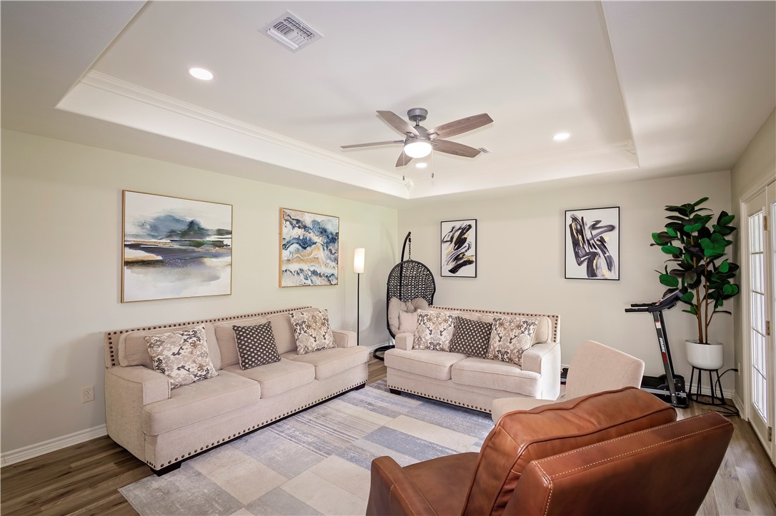 1217 O'Connell Street Corpus Christi, TX 78418 - Photo 9 of 23 a living room with furniture and a chandelier