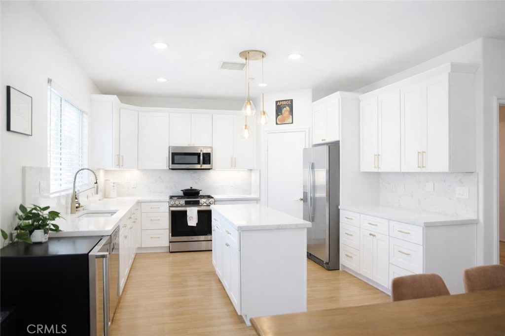 4689 Brookmore Court Riverside, CA 92505 - Photo 3 of 10 a kitchen with stainless steel appliances granite countertop a refrigerator sink and white cabinets