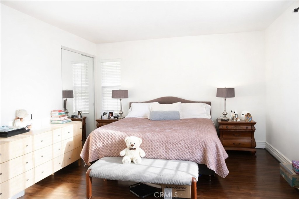 4689 Brookmore Court Riverside, CA 92505 - Photo 8 of 10 a bedroom with a bed and wooden floor