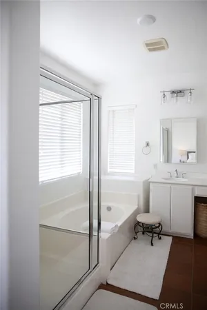 a spacious bathroom with a bathtub a sink and a window