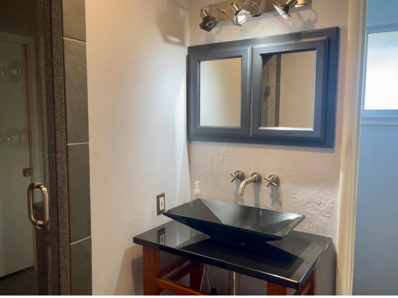 737 West Rialto Avenue Fresno, CA 93705 - Photo 11 of 11 a bathroom with a sink and a mirror