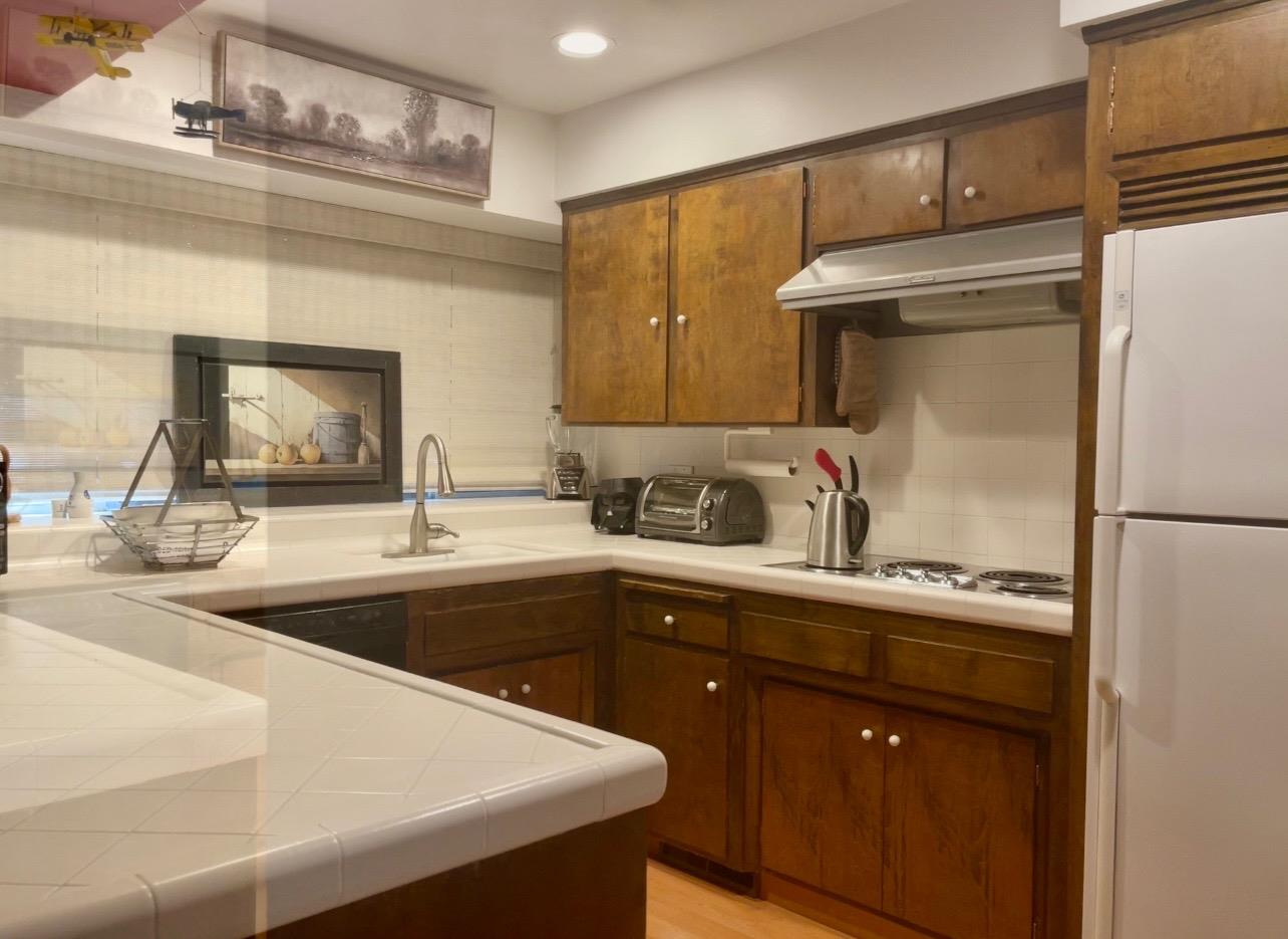 737 West Rialto Avenue Fresno, CA 93705 - Photo 4 of 11 a kitchen with a sink and a refrigerator