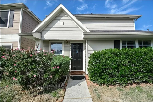 a view of a house with potted plants