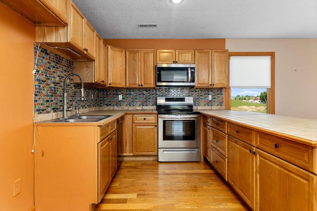 1476 Guthrie Road Staunton, VA 24401 - Photo 50 of 73 a kitchen with stainless steel appliances a stove sink and microwave