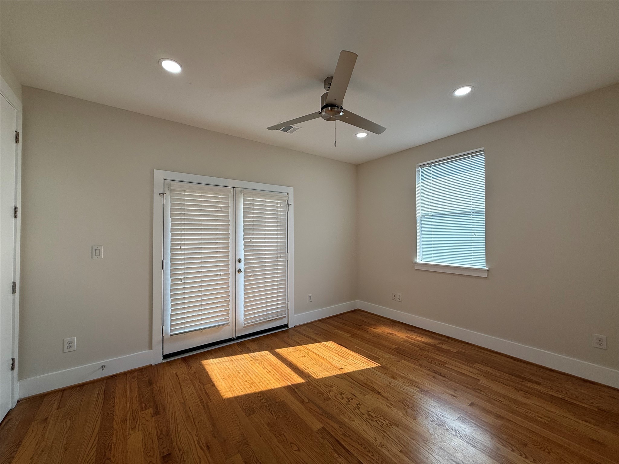 1608 Patterson Street, Unit A Houston, TX 77007 - Photo 18 of 20 an empty room with wooden floor cabinet and windows