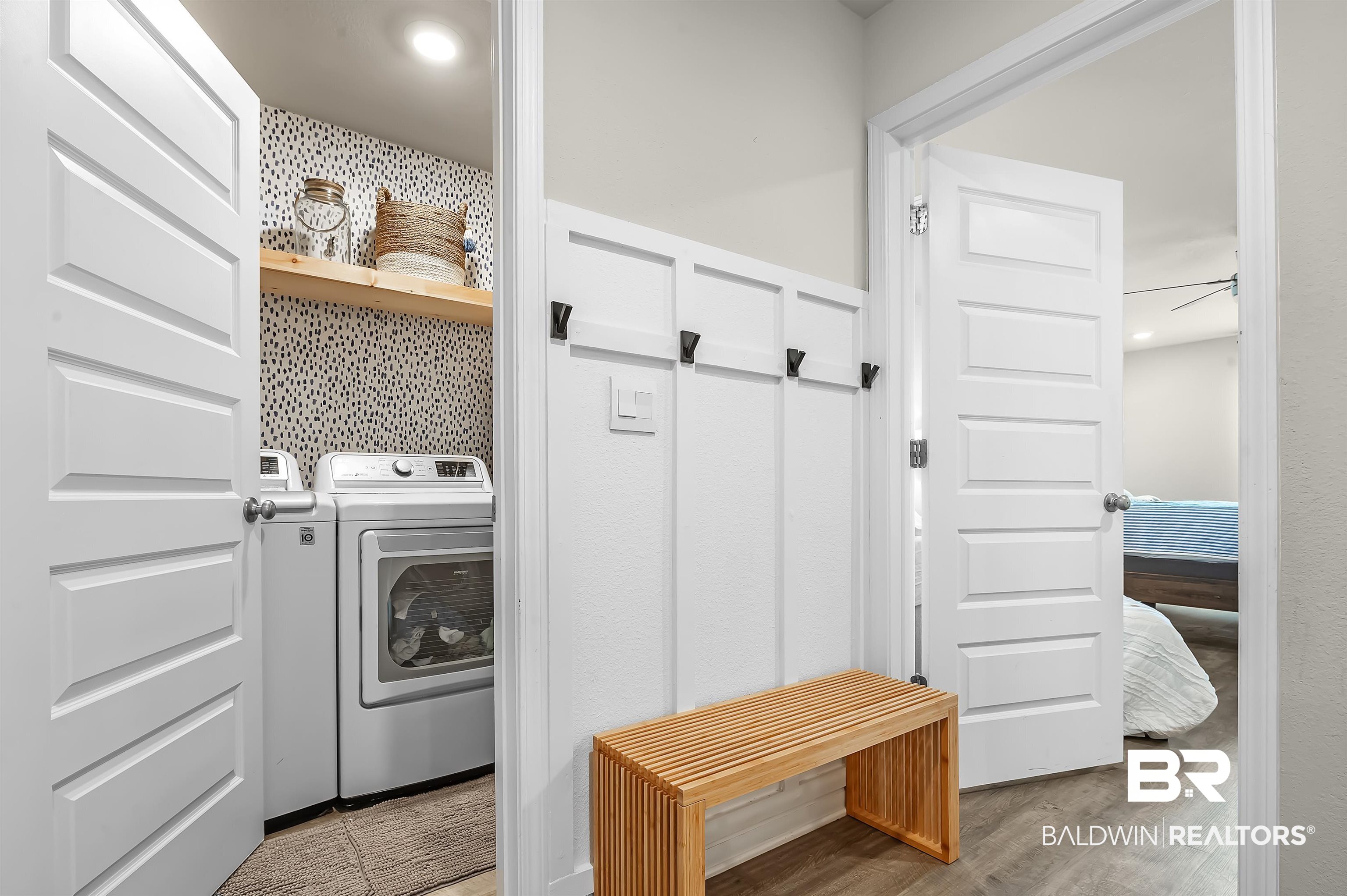 24549 Broken Sound Loop Orange Beach, AL 36561 - Photo 40 of 57 Clothes washing area with light hardwood / wood-style floors and washer / clothes dryer