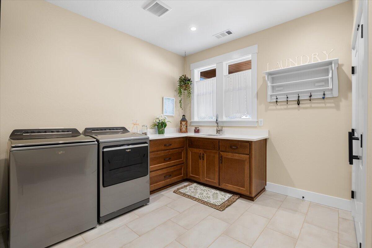 1323 Ellison Loop Merlin, OR 97532 - Photo 9 of 24 XLrg laundry room with blt in sink, cabinets and folding counter. Washer/Dryer included!