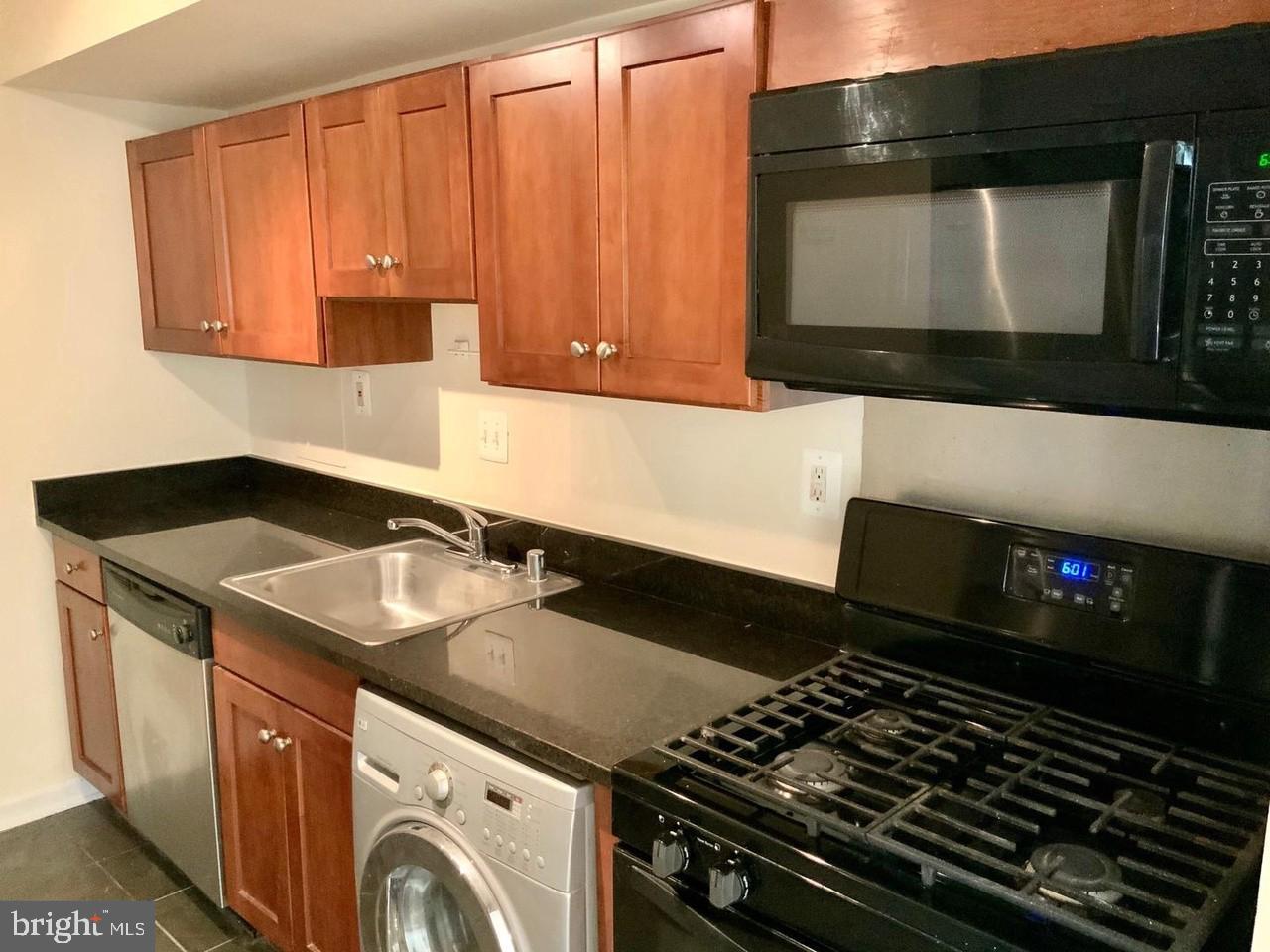 3109 Naylor Road Southeast, Unit C Washington, DC 20020 - Photo 8 of 20 a kitchen with a stove and a microwave