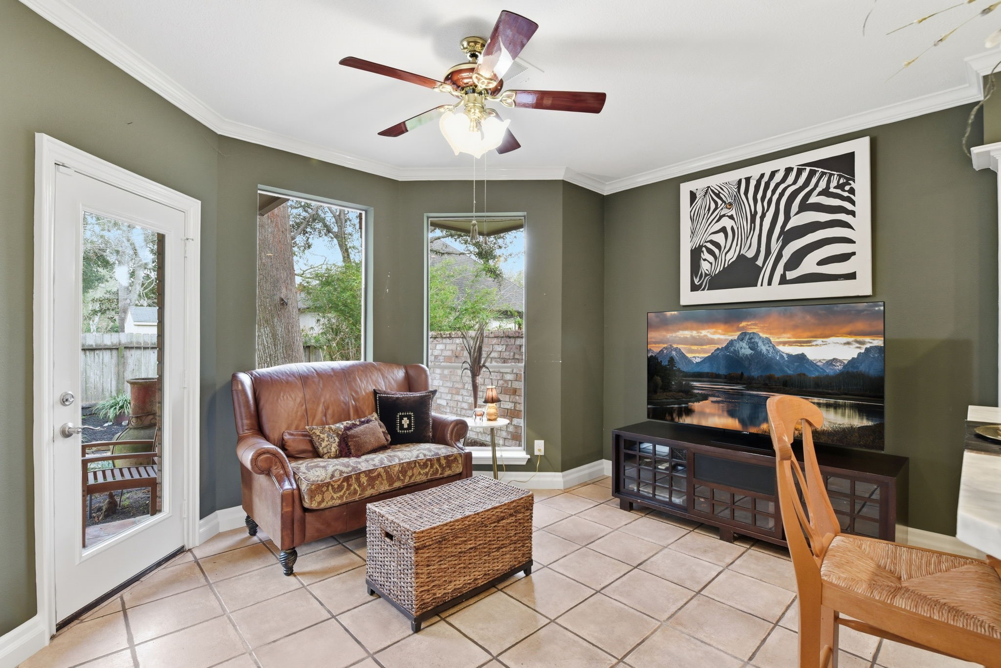 16322 Cranwood Drive Spring, TX 77379 - Photo 16 of 42 This inviting sitting area, connected to the kitchen, offers a cozy retreat with abundant natural light and a warm, welcoming atmosphere.