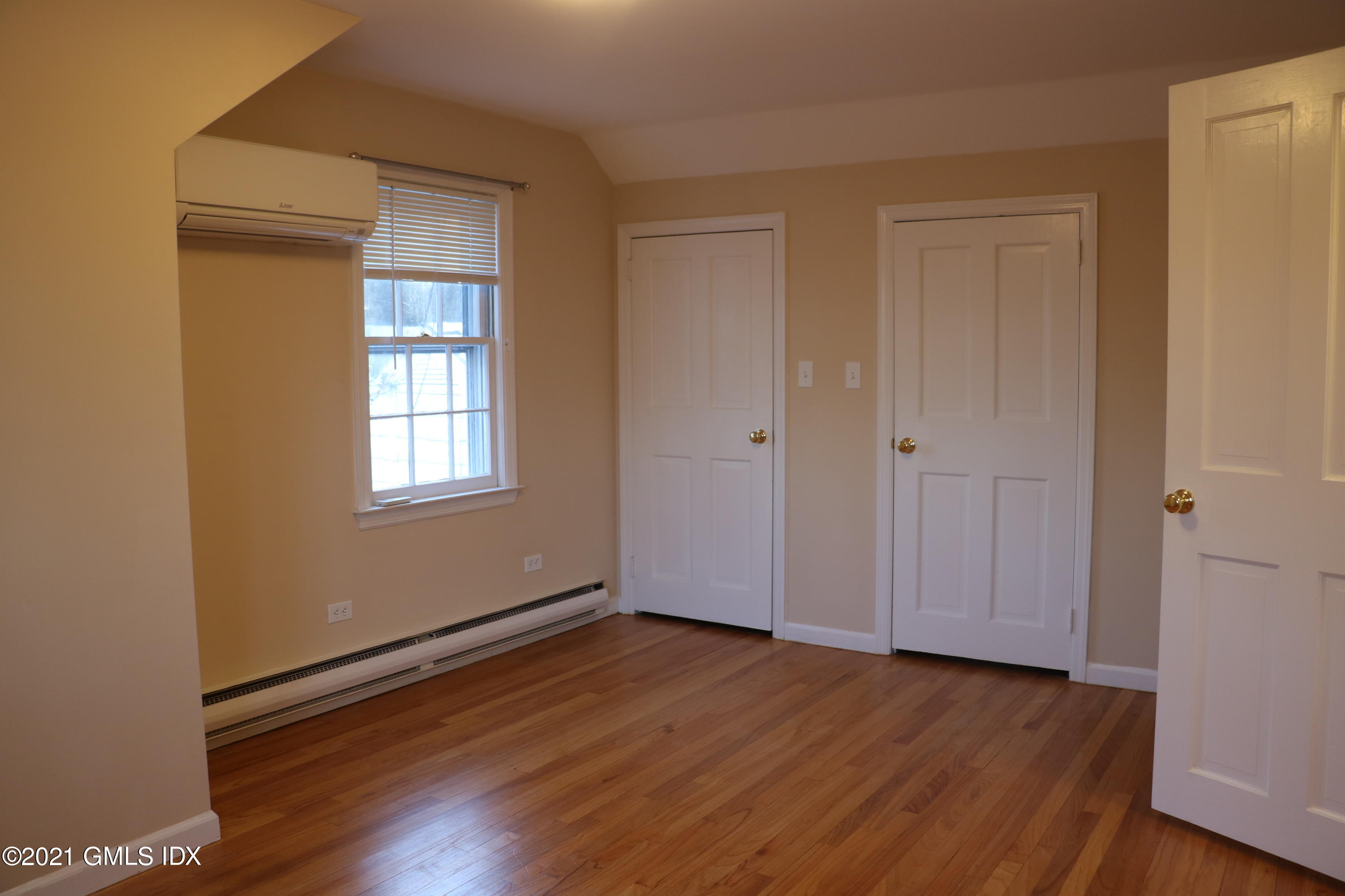 46 Ledge Brook Road Stamford, CT 06903 - Photo 13 of 23 a view of an empty room with wooden floor and a window