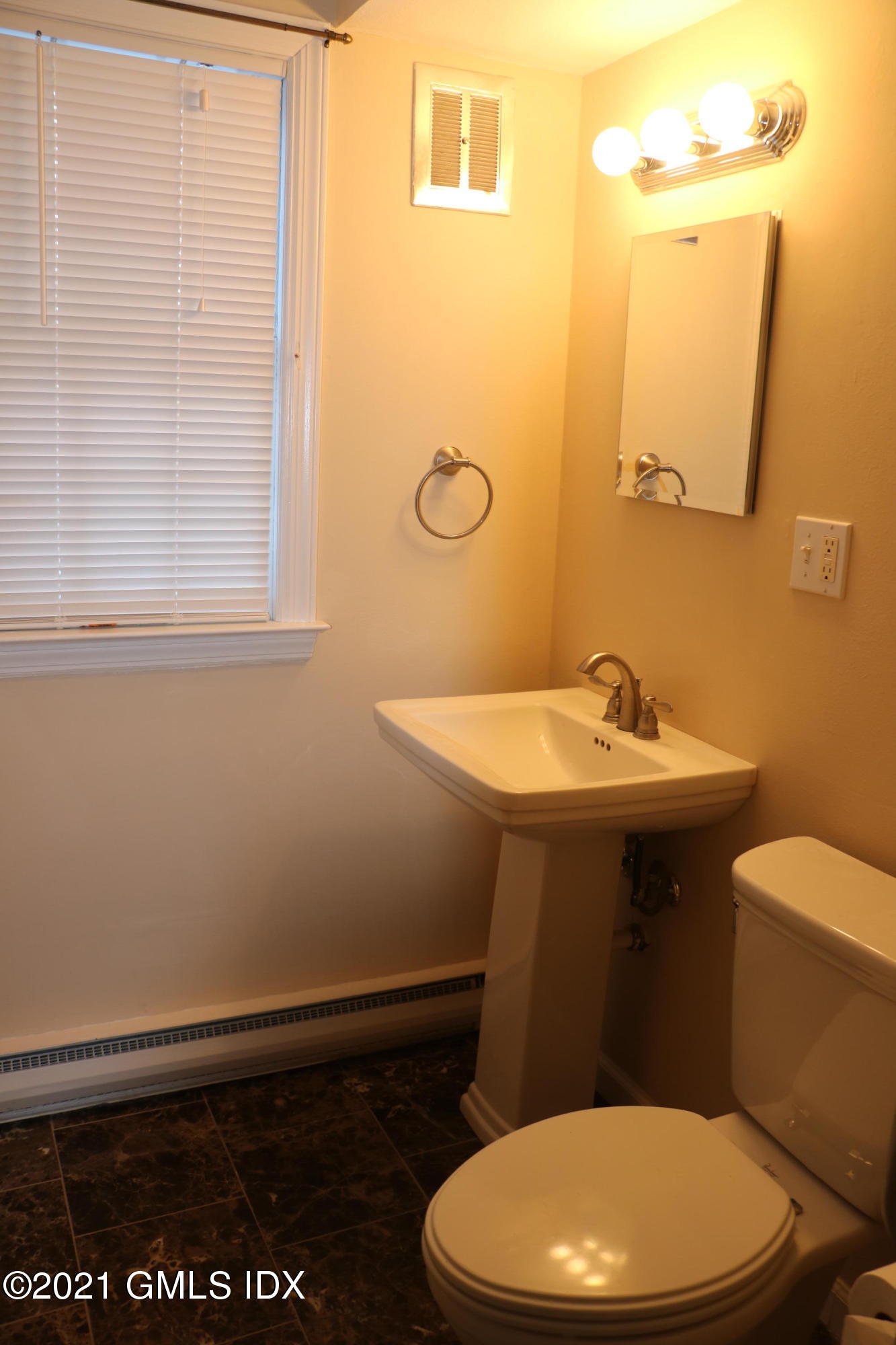 46 Ledge Brook Road Stamford, CT 06903 - Photo 17 of 23 a bathroom with a sink a toilet and mirror