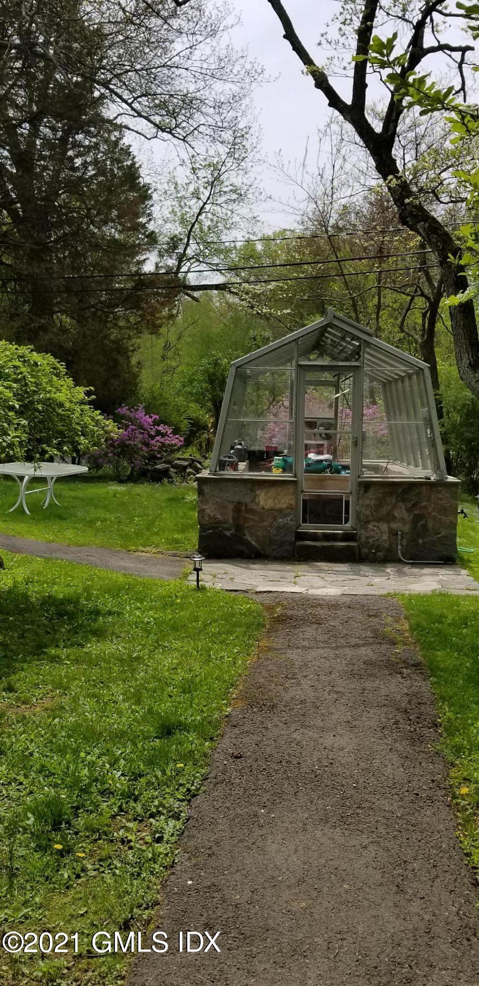 46 Ledge Brook Road Stamford, CT 06903 - Photo 22 of 23 a view of a tiny house with backyard