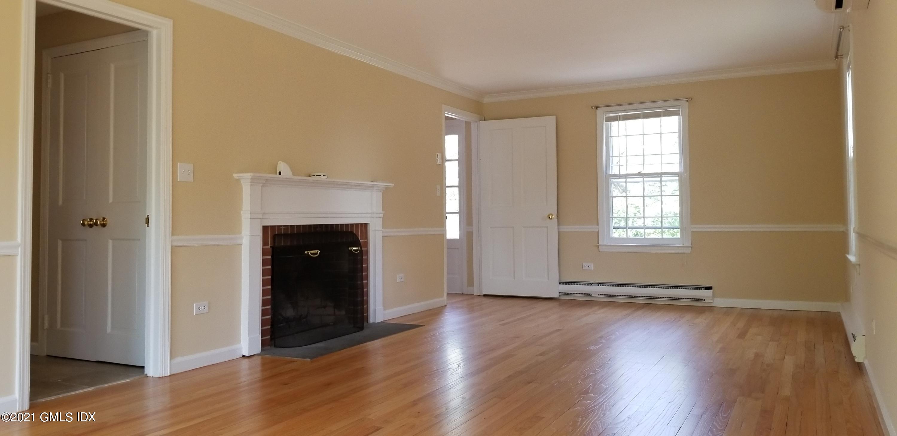 46 Ledge Brook Road Stamford, CT 06903 - Photo 4 of 23 an empty room with wooden floor and windows