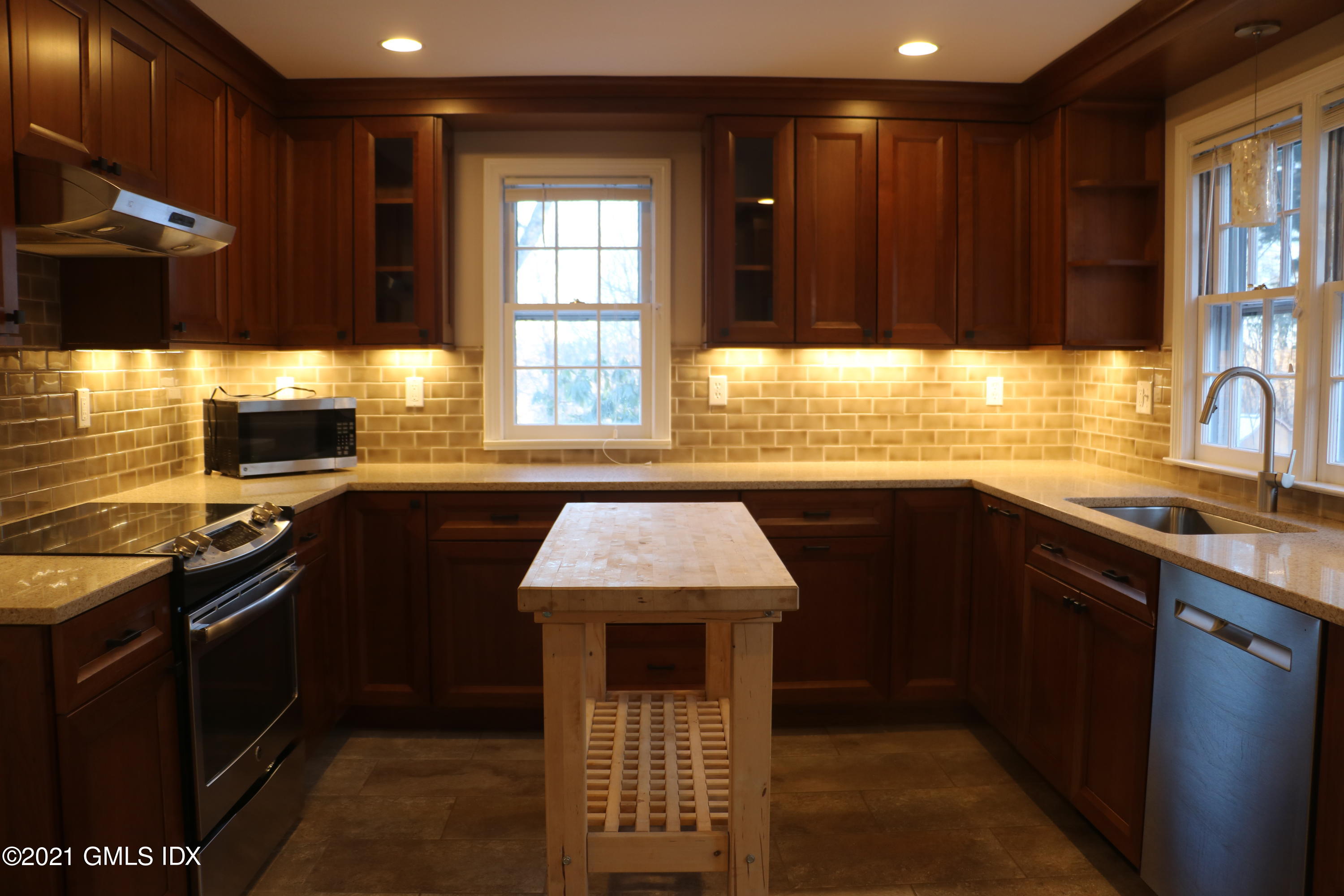 46 Ledge Brook Road Stamford, CT 06903 - Photo 6 of 23 a kitchen with stainless steel appliances kitchen island granite countertop a sink stove and granite counter top