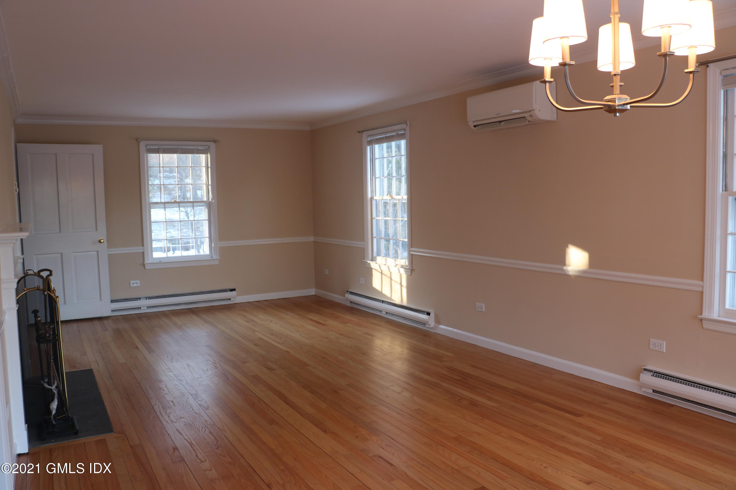 46 Ledge Brook Road Stamford, CT 06903 - Photo 10 of 23 an empty room with wooden floor and windows