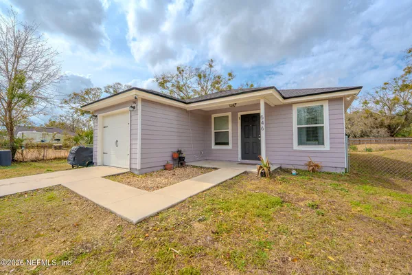 a view of a house with a yard and garage