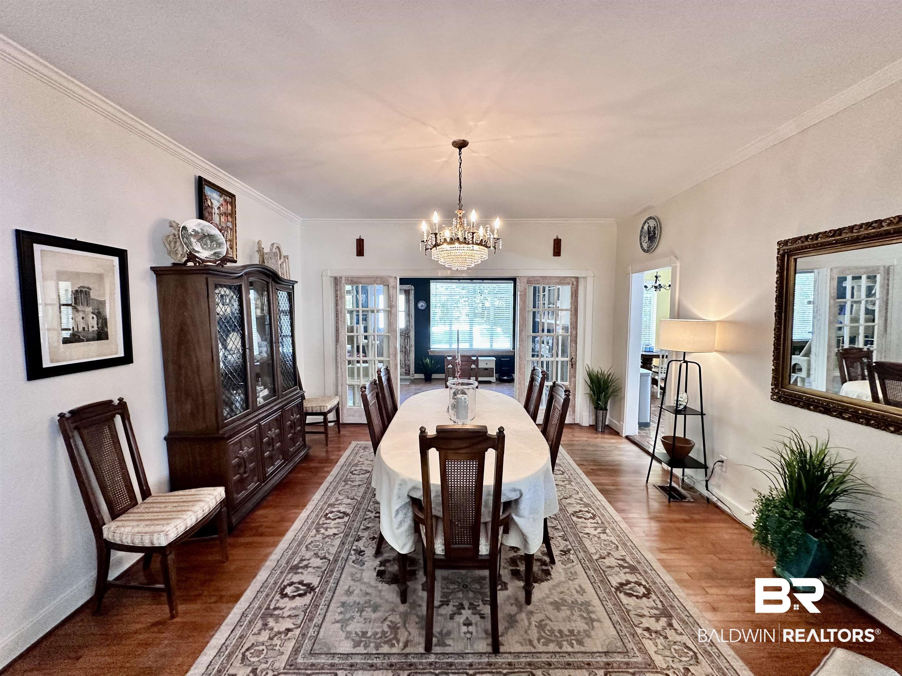 260 Siena Vista Street Mobile, AL 36607 - Photo 7 of 41 Dining space with a chandelier, wood finished floors, baseboards, and ornamental molding