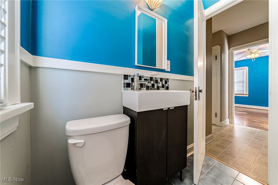 6711 Forest Avenue Parma, OH 44129 - Photo 20 of 33 Bathroom featuring vanity, tile patterned floors, a ceiling fan, and backsplash