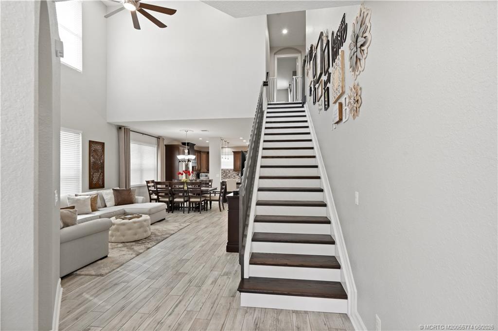 1268 Southeast Kirk Street Stuart, FL 34997 - Photo 13 of 63 a living room with lots of furniture and wooden floor