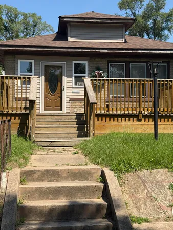 a view of a house with backyard and porch