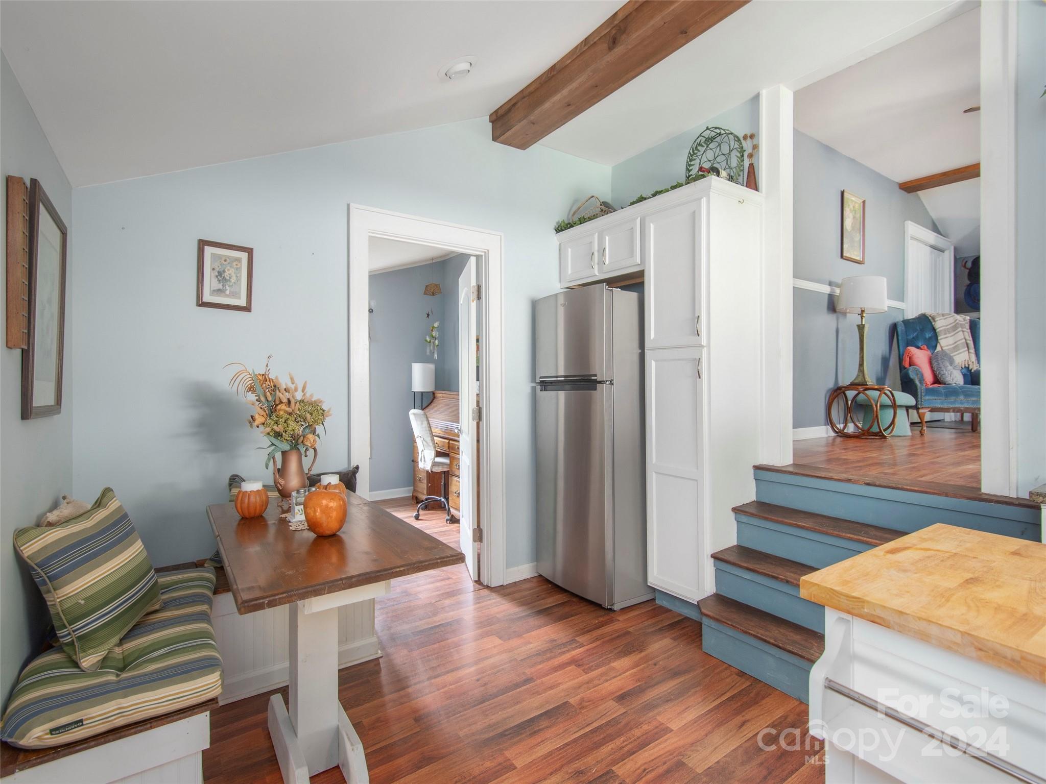 883 Price Town Road Clyde, NC 28721 - Photo 13 of 34 a living room with furniture and a refrigerator