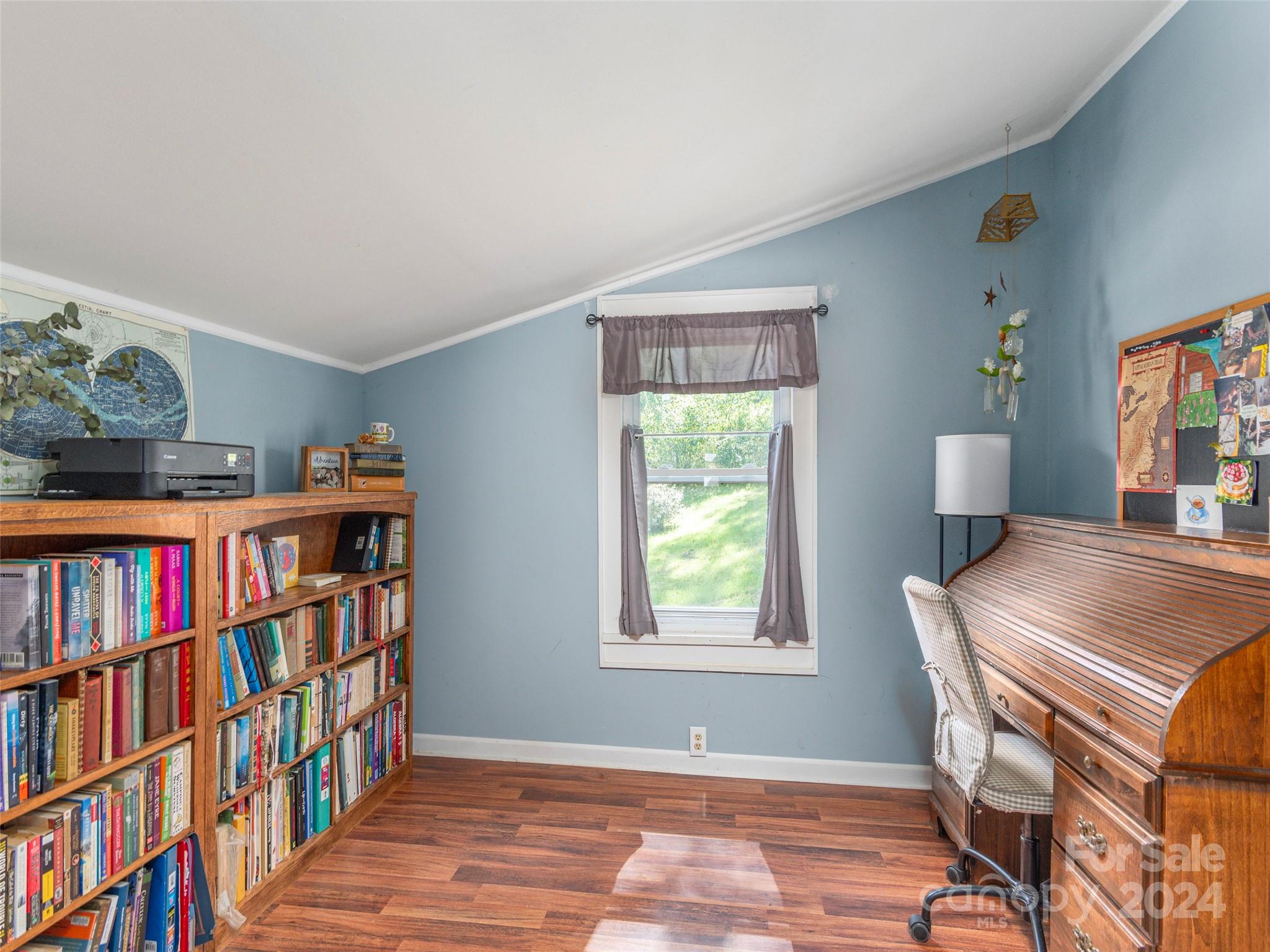 883 Price Town Road Clyde, NC 28721 - Photo 21 of 34 a room with a book shelf and a window