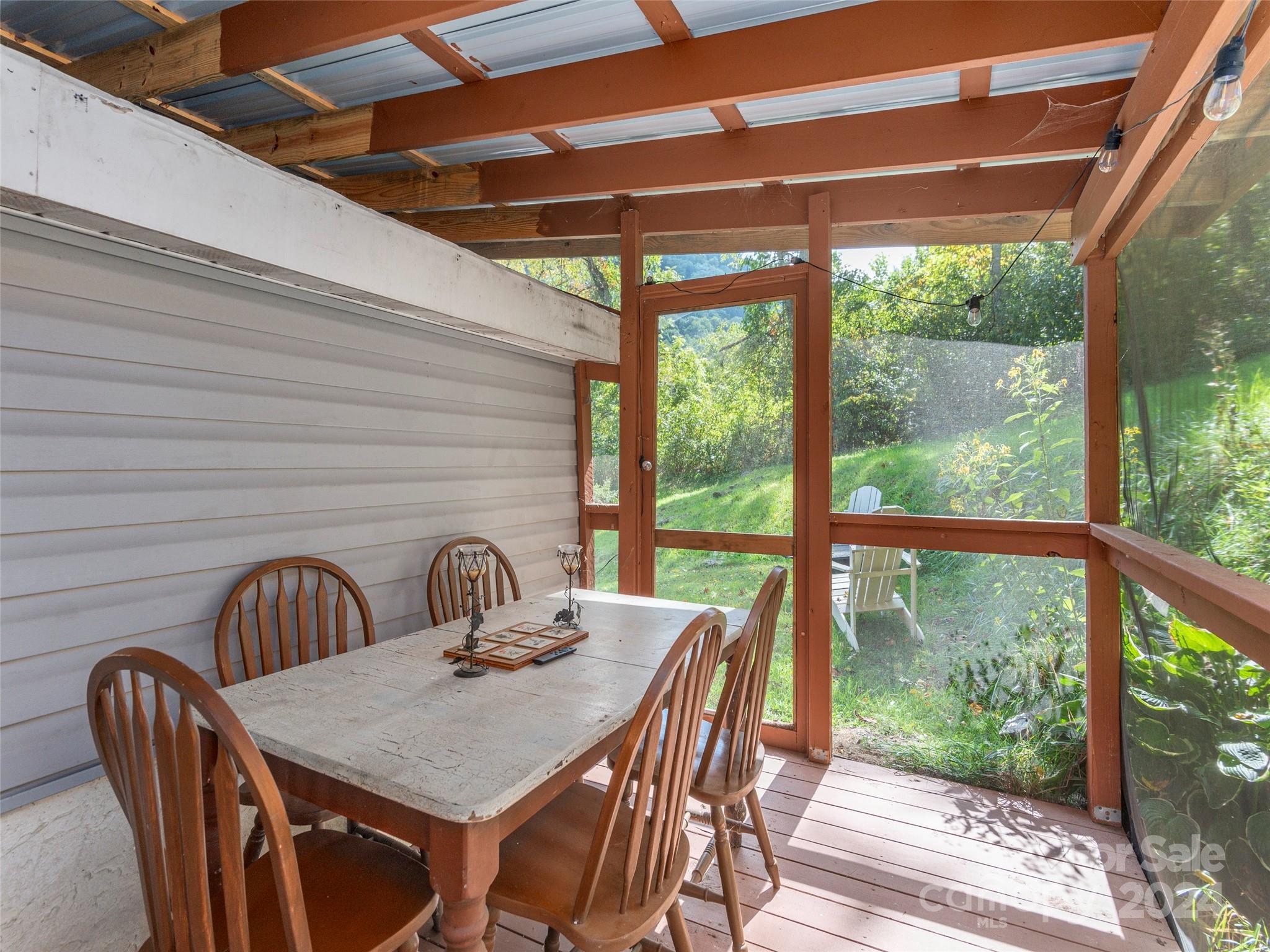 883 Price Town Road Clyde, NC 28721 - Photo 22 of 34 a table and chairs in a balcony