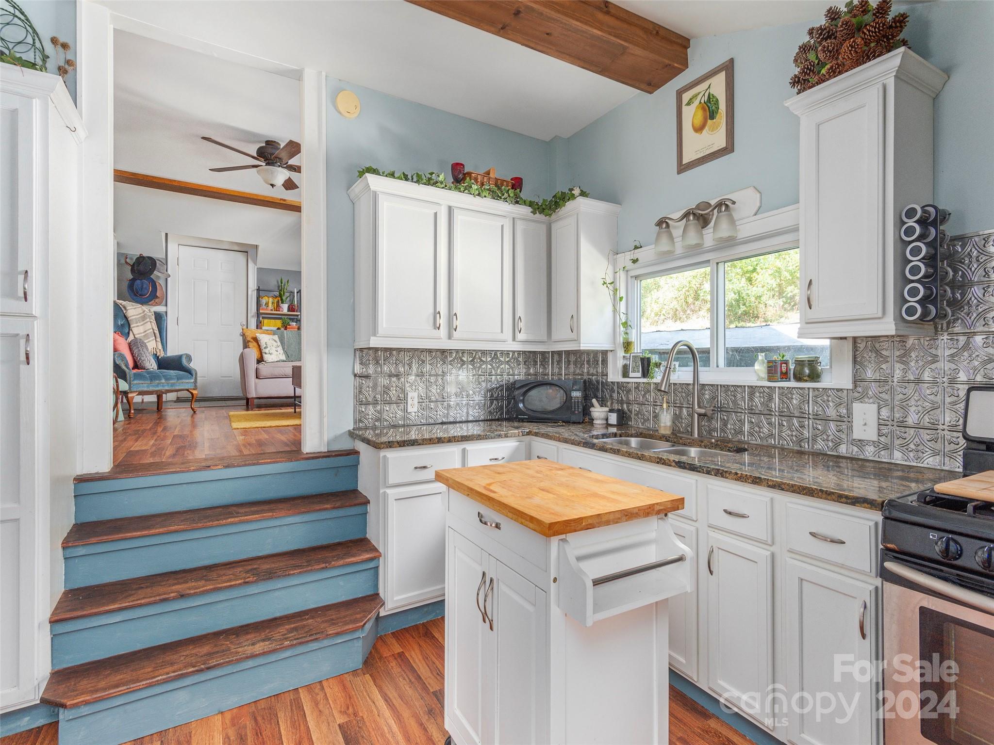 883 Price Town Road Clyde, NC 28721 - Photo 4 of 34 a kitchen that has a sink and a stove in it