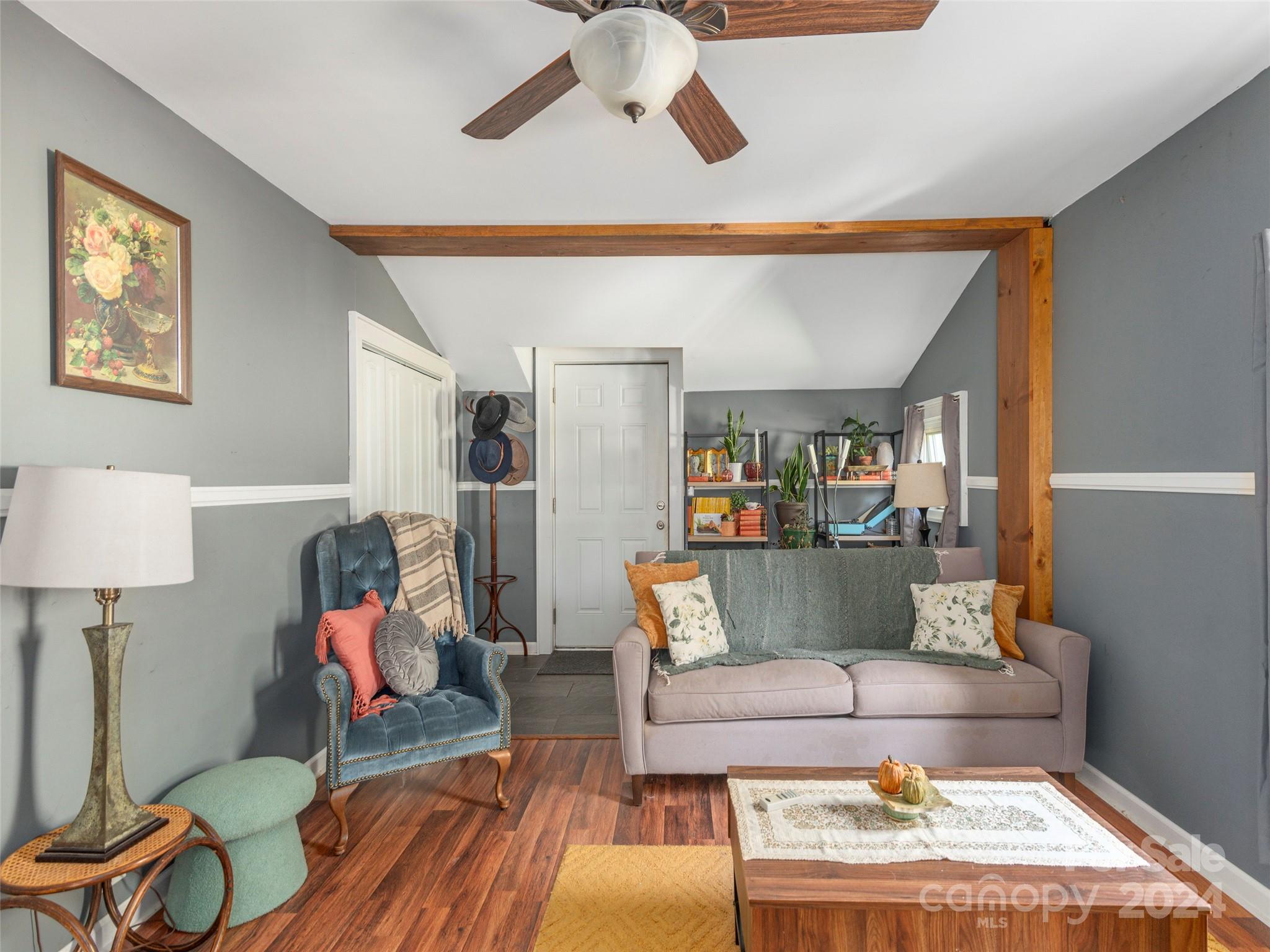 883 Price Town Road Clyde, NC 28721 - Photo 6 of 34 a living room with furniture and a wooden floor