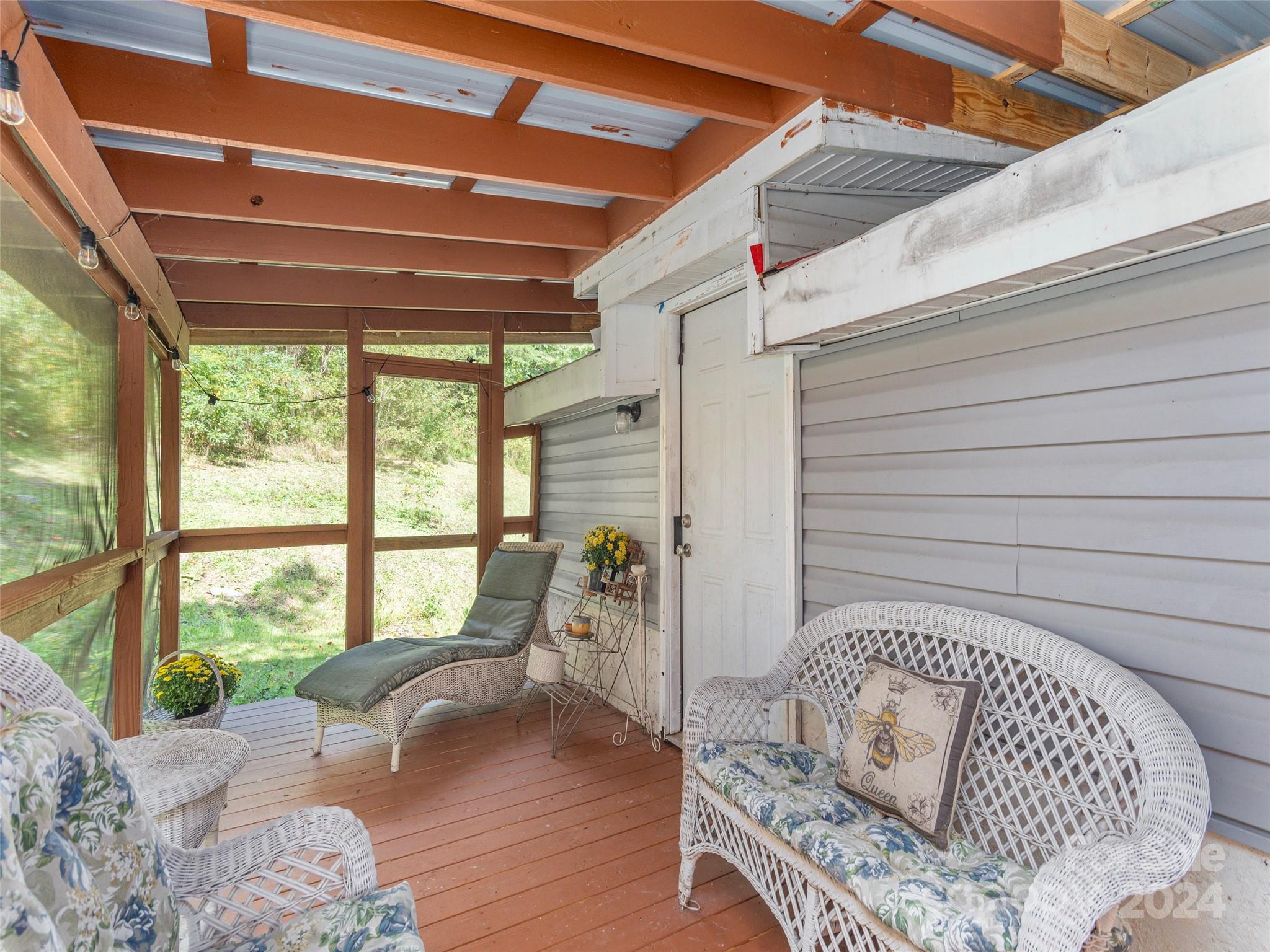 883 Price Town Road Clyde, NC 28721 - Photo 7 of 34 a bed sitting in a bedroom next to a window