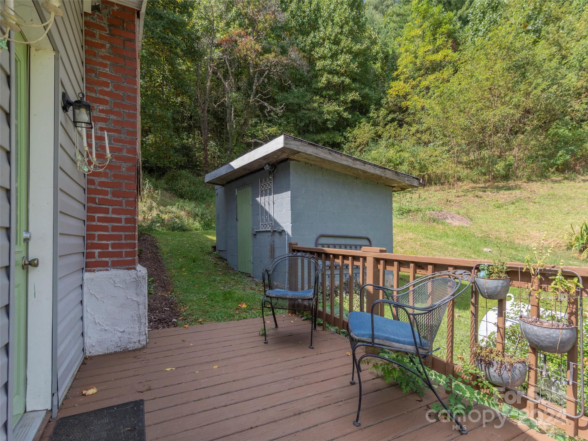 883 Price Town Road Clyde, NC 28721 - Photo 8 of 34 a view of a chair and table on the wooden floor