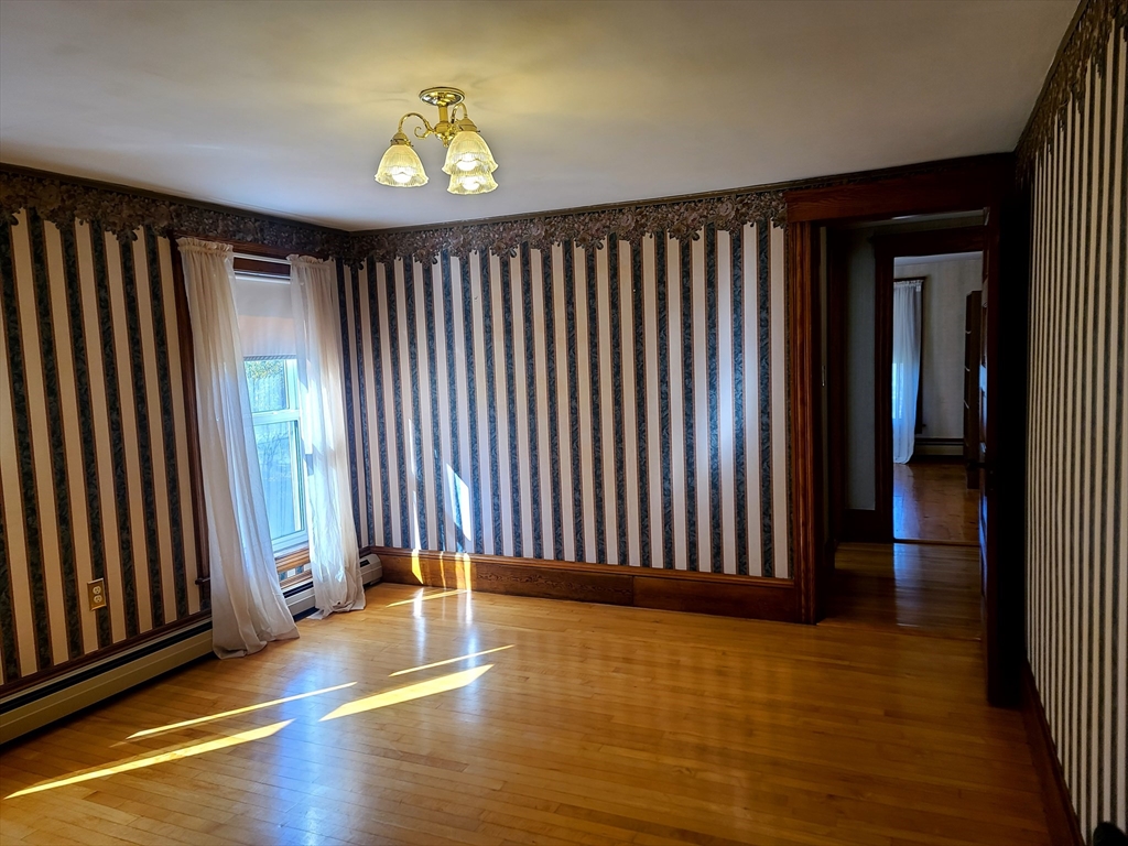 10 Maple Avenue Grafton, MA 01560 - Photo 3 of 9 an empty room with wooden floor and windows