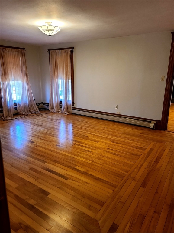 10 Maple Avenue Grafton, MA 01560 - Photo 7 of 9 an empty room with wooden floor and windows