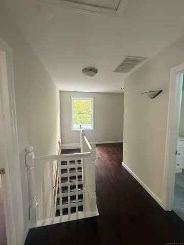 a view of wooden floor and windows in a room