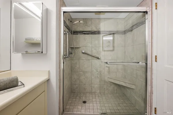 a bathroom with a shower and a sink