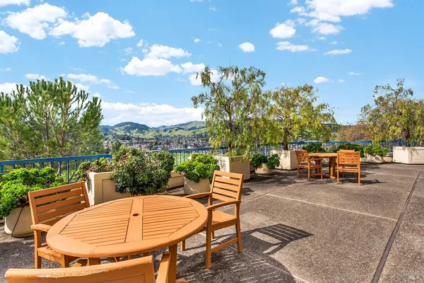 a backyard of a house with table and chairs