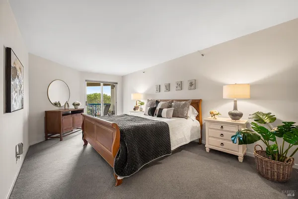 a bed room with a bed and a potted plant